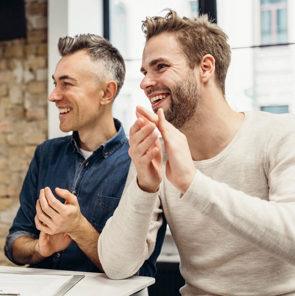 Men discussing business while smiling