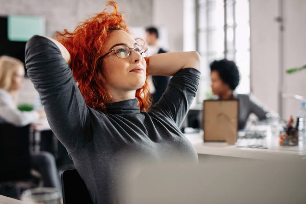 Satisfied redhead businesswoman resting